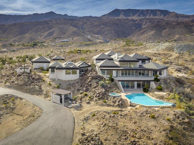 exterior space with a mountain view and a patio area