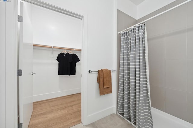 bathroom with hardwood / wood-style flooring and a shower with curtain