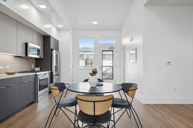 dining space with light hardwood / wood-style floors