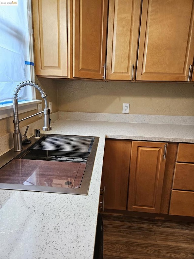 kitchen with dark wood-type flooring and sink