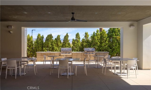 view of patio featuring ceiling fan, area for grilling, and grilling area