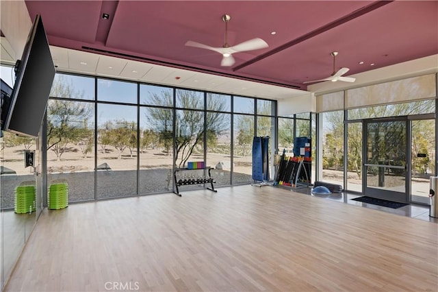 3712 Ambassador Dr, Palm Springs, CA 92262 - exercise room with floor to ceiling windows, wood finished floors, and a ceiling fan