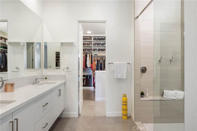 3712 Ambassador Dr, Palm Springs, CA 92262 - full bath featuring a walk in closet, a tile shower, tile patterned floors, a sink, and double vanity