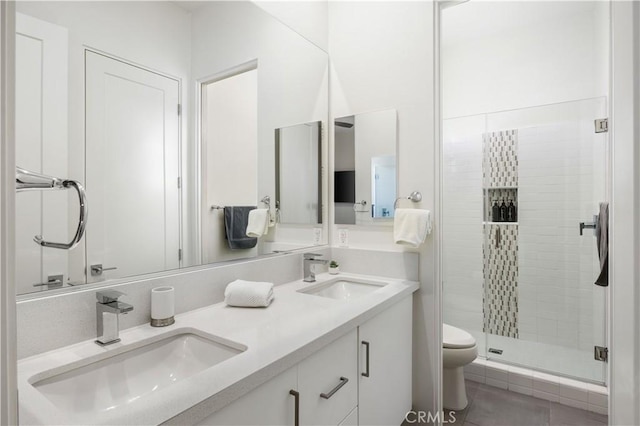 bathroom featuring vanity, a shower with shower door, and toilet