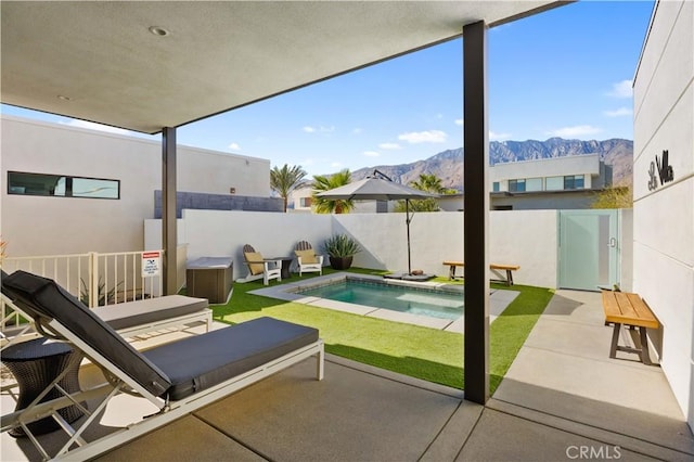 view of pool with a mountain view and a patio area