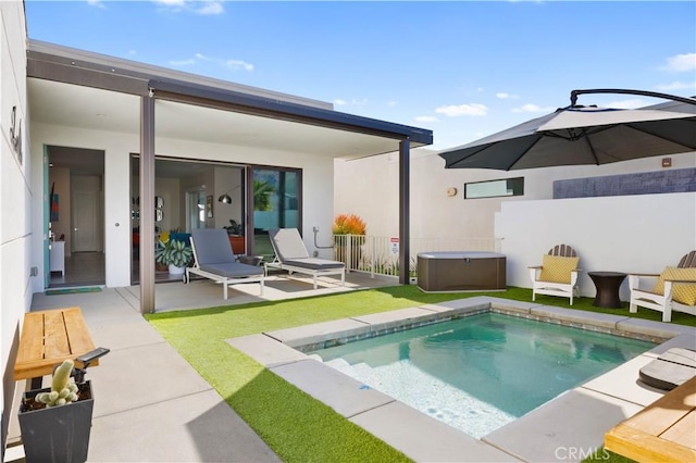 back of house featuring a pool with hot tub and a patio