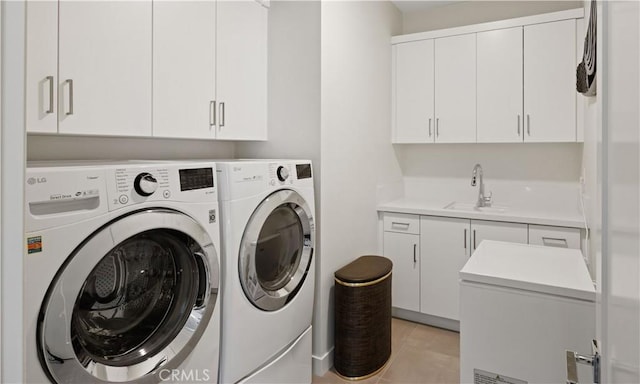 3712 Ambassador Dr, Palm Springs, CA 92262 - laundry room featuring washer and dryer, cabinet space, a sink, and light tile patterned floors