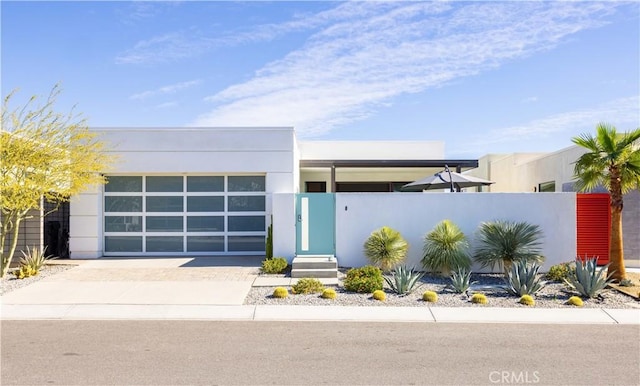 3712 Ambassador Dr, Palm Springs, CA 92262 - view of front of home with stucco siding, driveway, a fenced front yard, and an attached garage