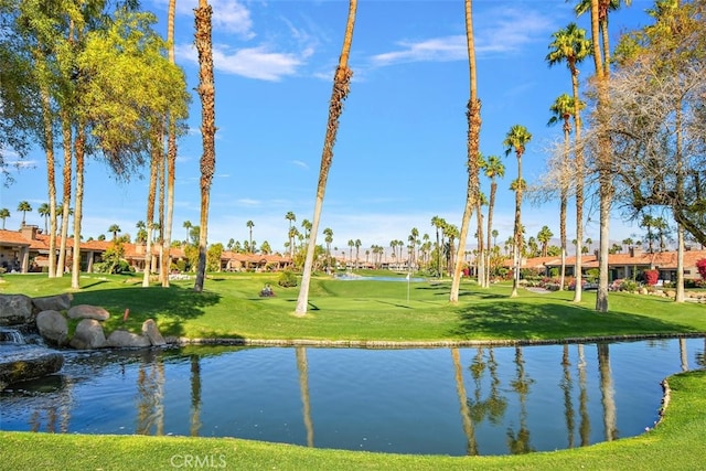 view of property's community featuring a yard and a water view