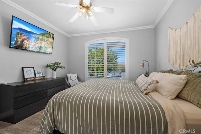 bedroom featuring ornamental molding, wood-type flooring, and ceiling fan