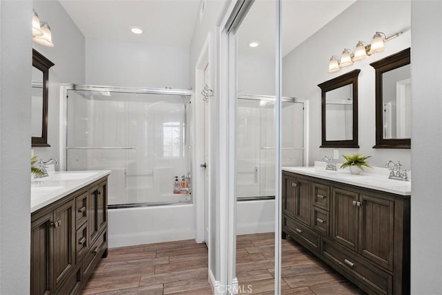 bathroom featuring enclosed tub / shower combo and vanity