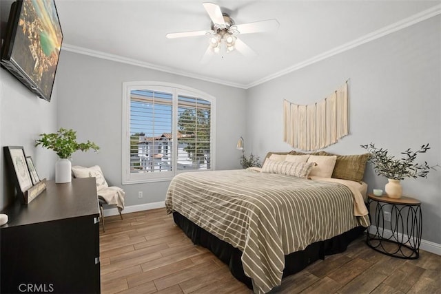 bedroom with crown molding, wood-type flooring, and ceiling fan