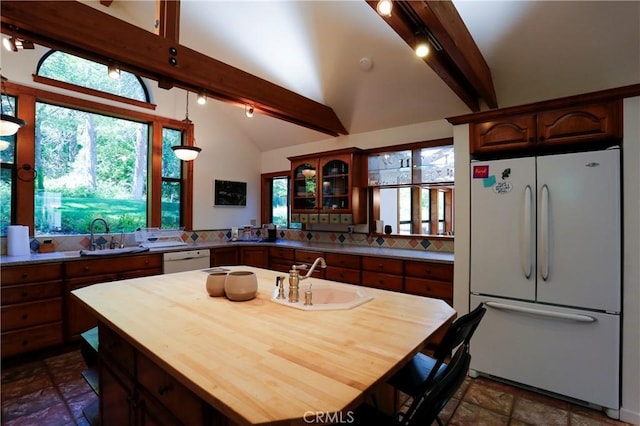 kitchen featuring lofted ceiling with beams, sink, white appliances, and kitchen peninsula