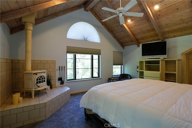 bedroom featuring beam ceiling, high vaulted ceiling, dark carpet, wooden ceiling, and a wood stove