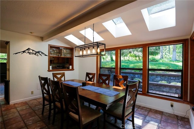 dining area featuring vaulted ceiling with beams and an inviting chandelier