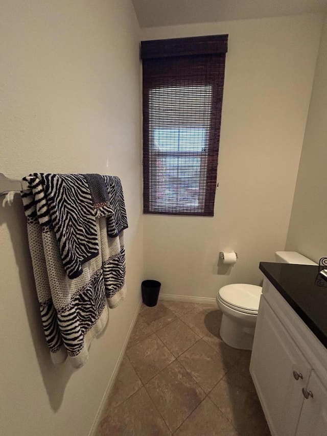 bathroom with vanity, toilet, and tile patterned flooring