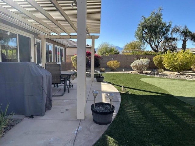 view of patio featuring area for grilling and a pergola