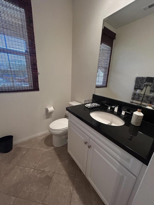 bathroom with tile patterned floors, vanity, and toilet