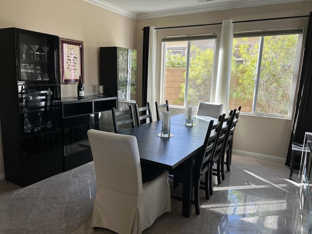 dining area featuring crown molding and plenty of natural light