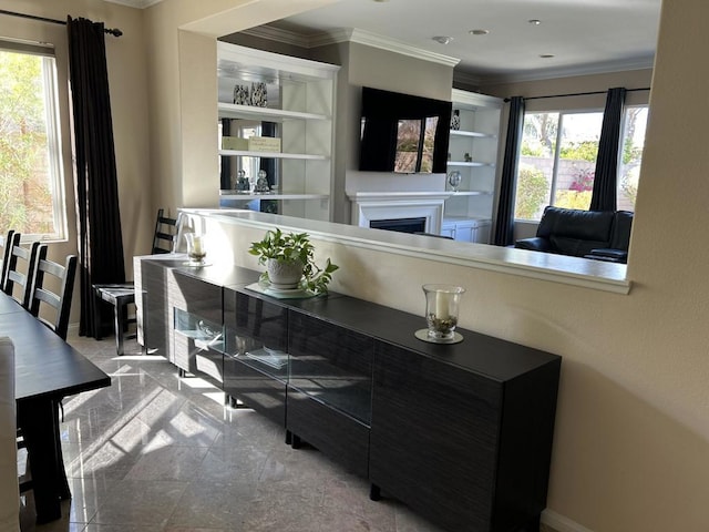 bar featuring crown molding and a healthy amount of sunlight