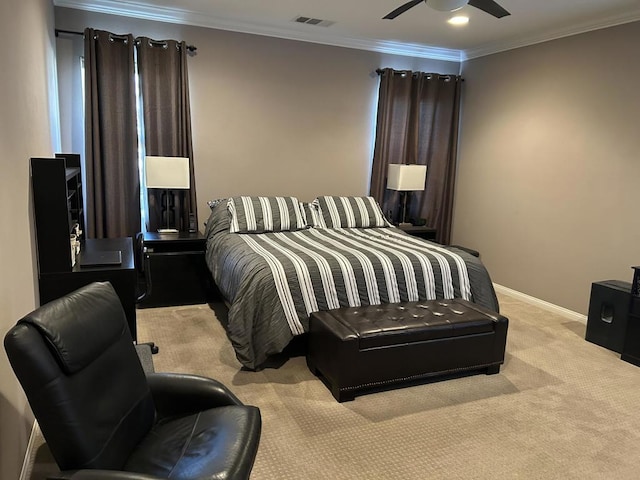 carpeted bedroom with ceiling fan and ornamental molding