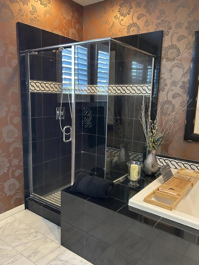 bathroom featuring a shower with shower door