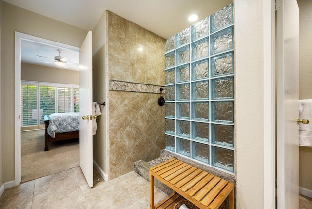 bathroom with tiled shower and ceiling fan