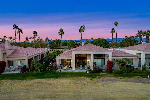 view of front of house featuring a yard and a patio