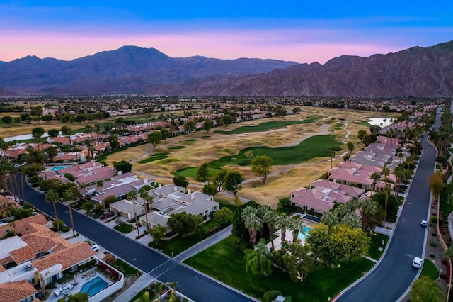 aerial view at dusk featuring a mountain view