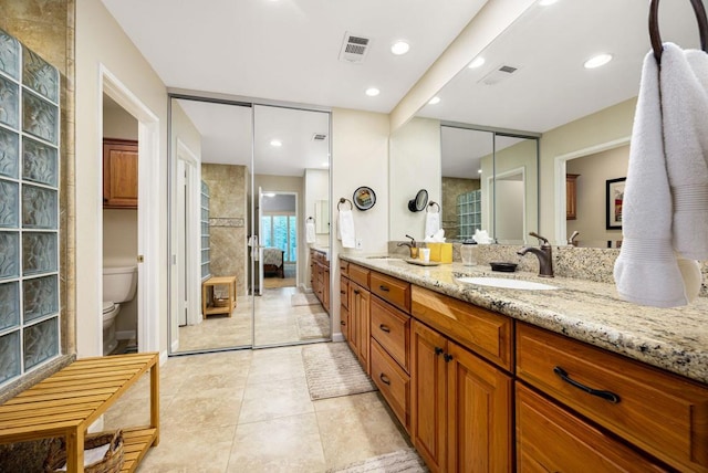 bathroom with vanity, toilet, and tile patterned flooring