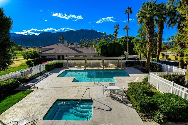 view of swimming pool featuring a patio and a mountain view