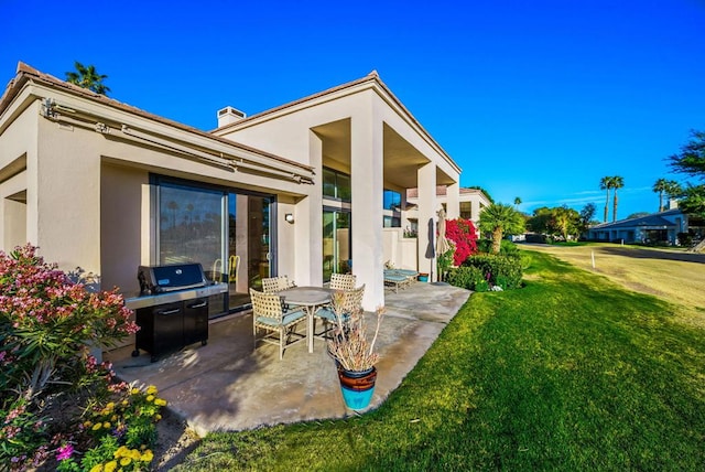 rear view of property with a patio area and a lawn