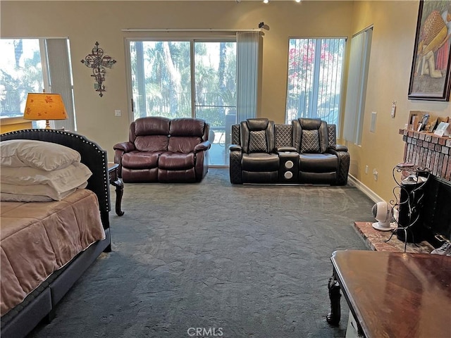 living room featuring a brick fireplace and carpet