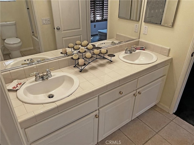 full bathroom with tile patterned flooring, vanity, washtub / shower combination, and toilet