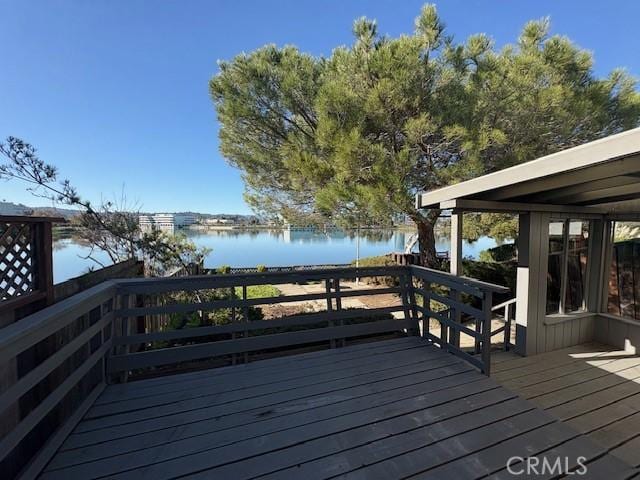 wooden deck featuring a water view