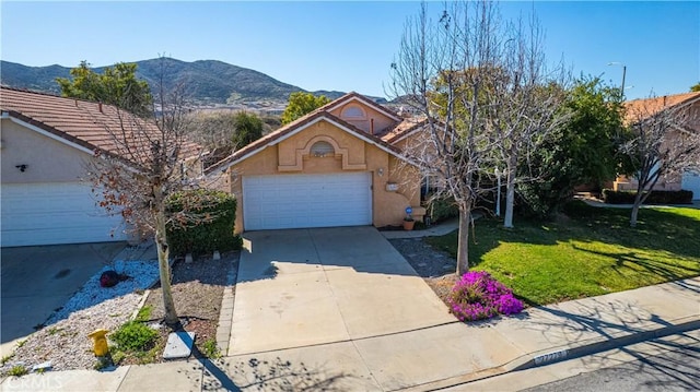 view of front facade featuring stucco siding, a mountain view, a garage, a tiled roof, and a front lawn