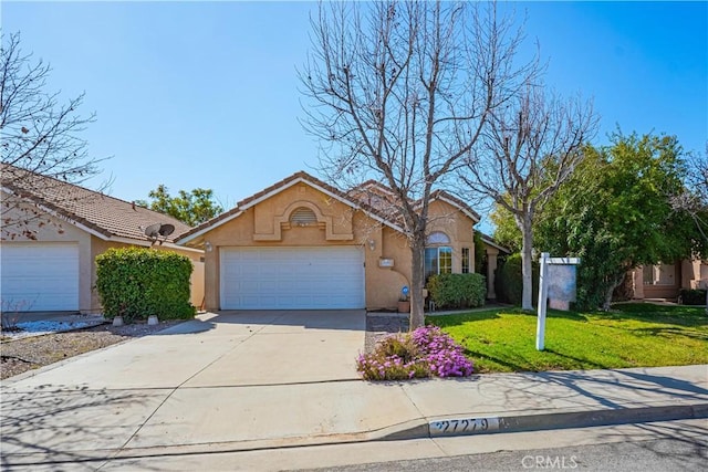 view of front of house with stucco siding, concrete driveway, a garage, a tiled roof, and a front lawn