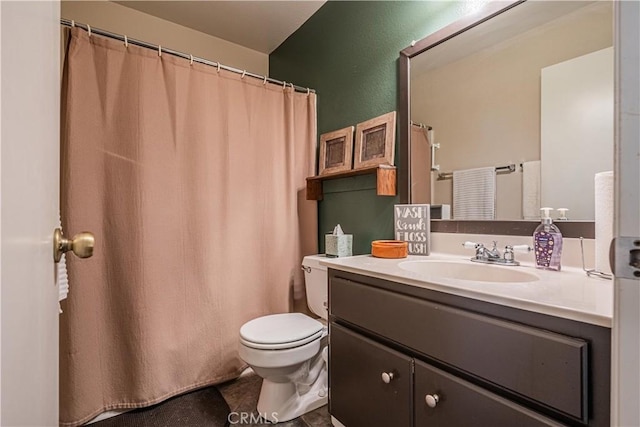 full bath featuring vanity, toilet, and tile patterned floors