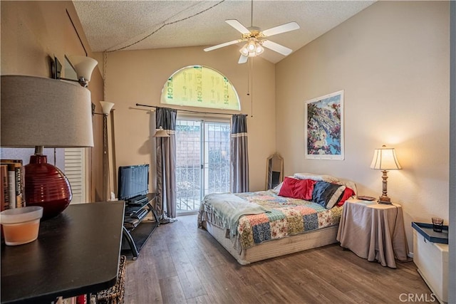 bedroom with a textured ceiling, ceiling fan, wood finished floors, vaulted ceiling, and access to outside