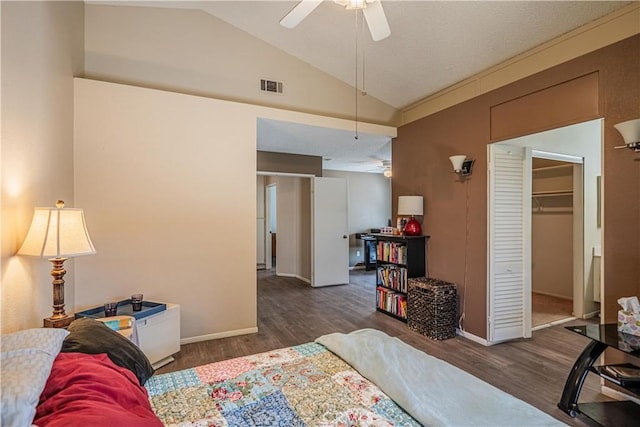 bedroom featuring vaulted ceiling, dark wood-type flooring, a closet, and visible vents