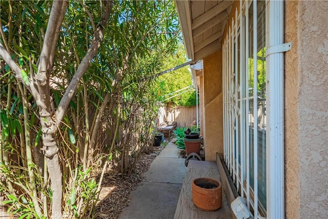 view of property exterior with fence and stucco siding