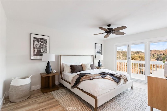 bedroom featuring access to exterior, light hardwood / wood-style floors, and ceiling fan