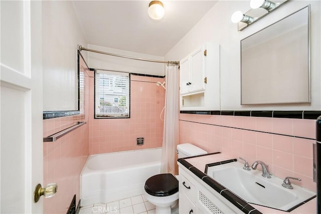 full bathroom with tile patterned floors, toilet, tile walls, vanity, and shower / bath combination with curtain