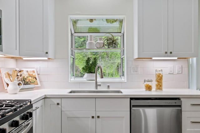 kitchen featuring white cabinetry, dishwasher, sink, and backsplash