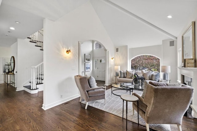 living room featuring dark wood-type flooring and high vaulted ceiling