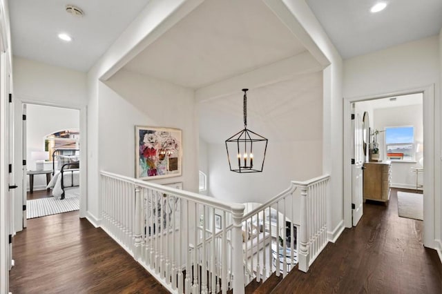 hallway featuring a chandelier and dark hardwood / wood-style flooring