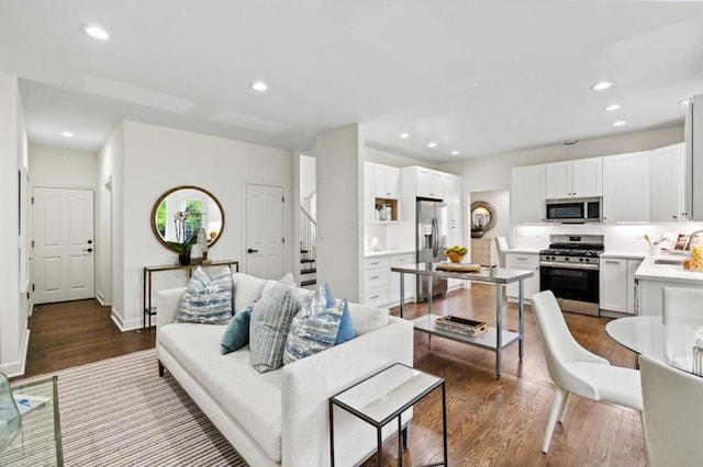 living room featuring dark hardwood / wood-style flooring and sink