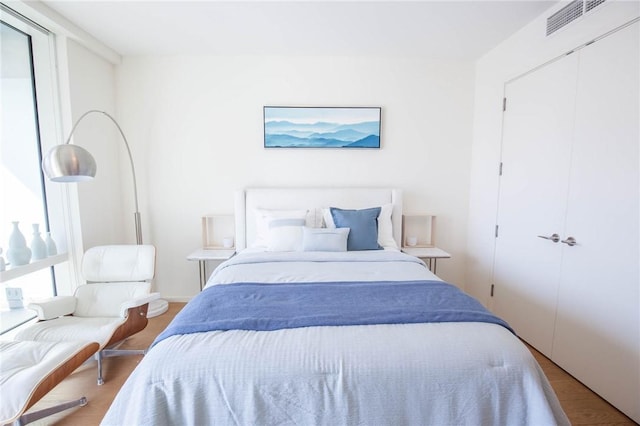 bedroom with hardwood / wood-style flooring and a closet