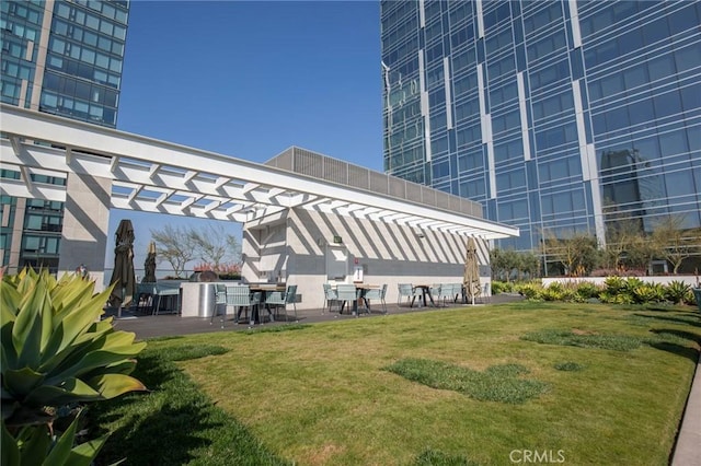 exterior space with a pergola, a lawn, and a patio area