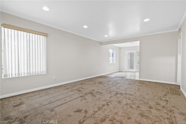 carpeted spare room featuring ornamental molding